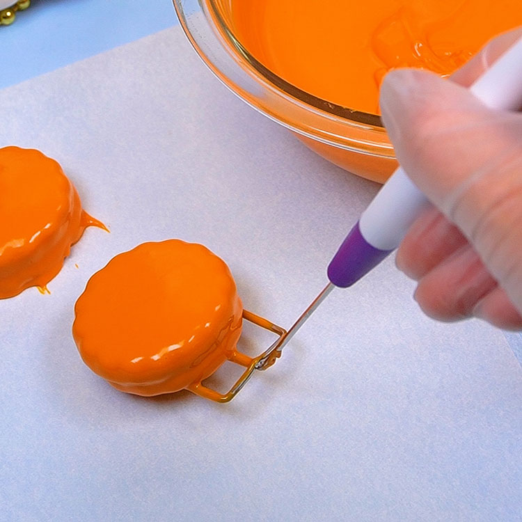 dipping cookie into melted chocolate