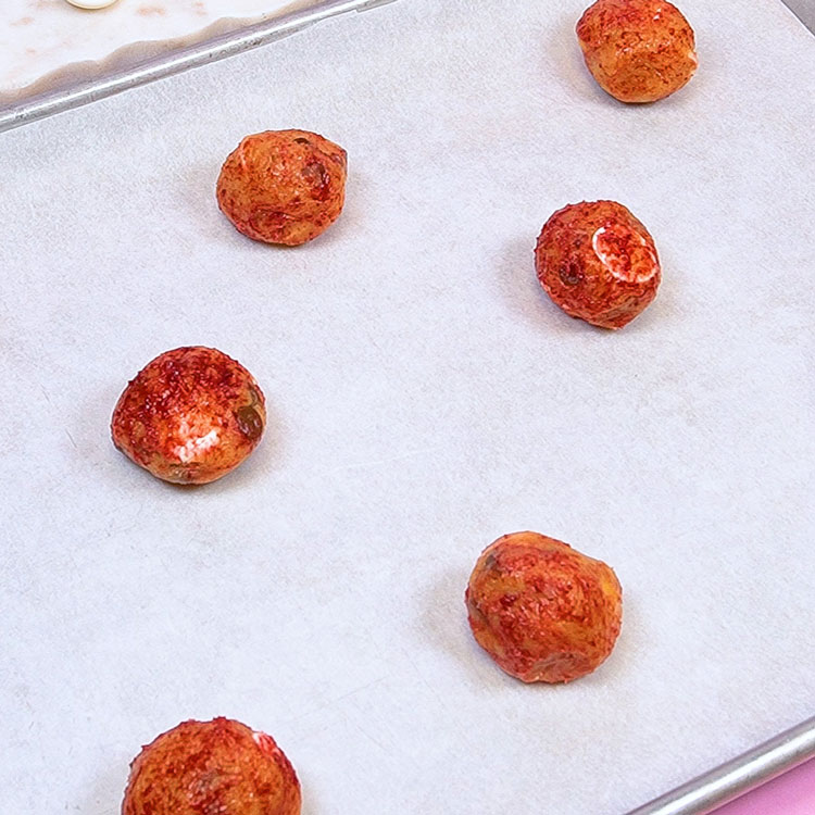 cookie dough balls on cookie sheet